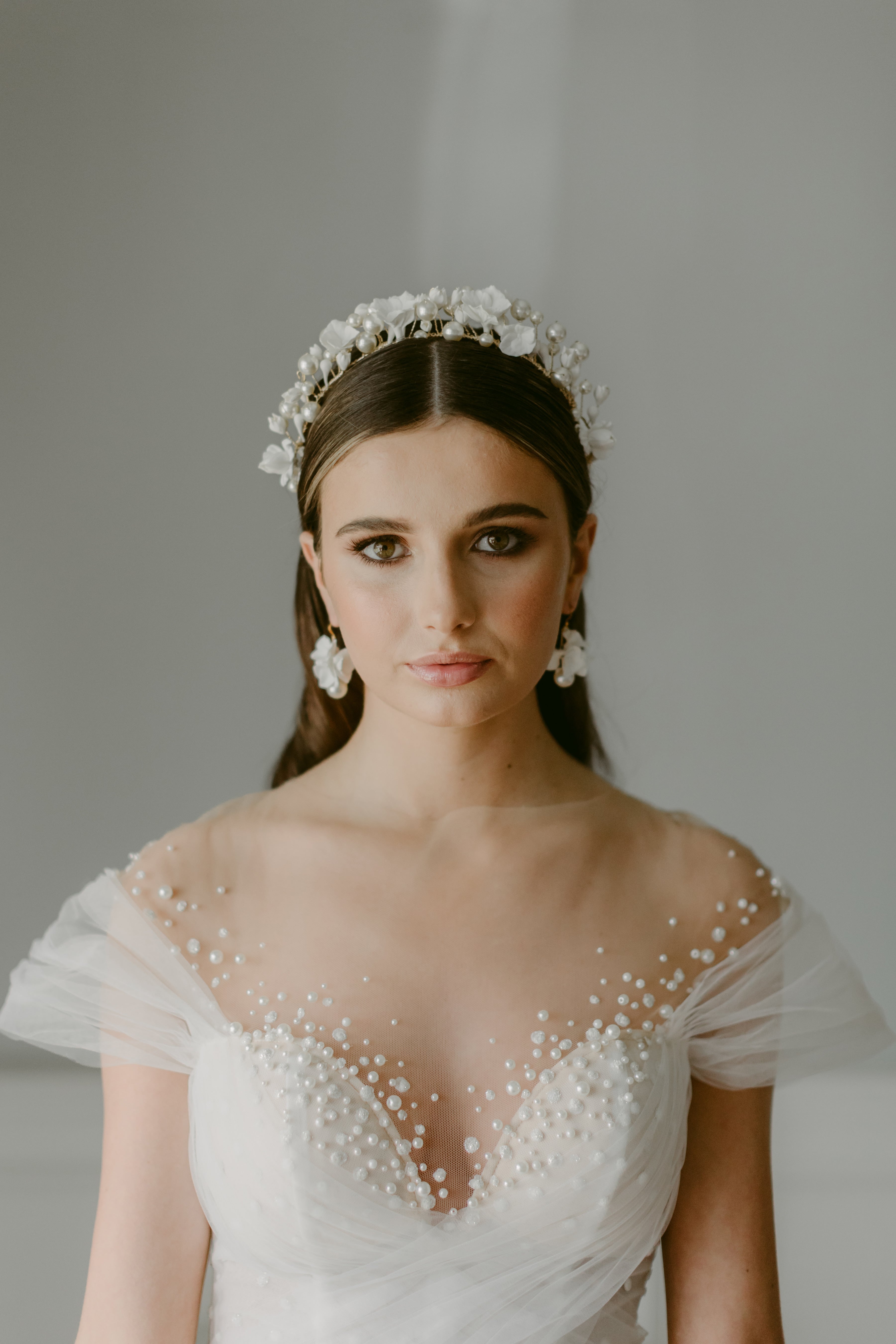 bride wearing a bridal crown and earrings by megan therese