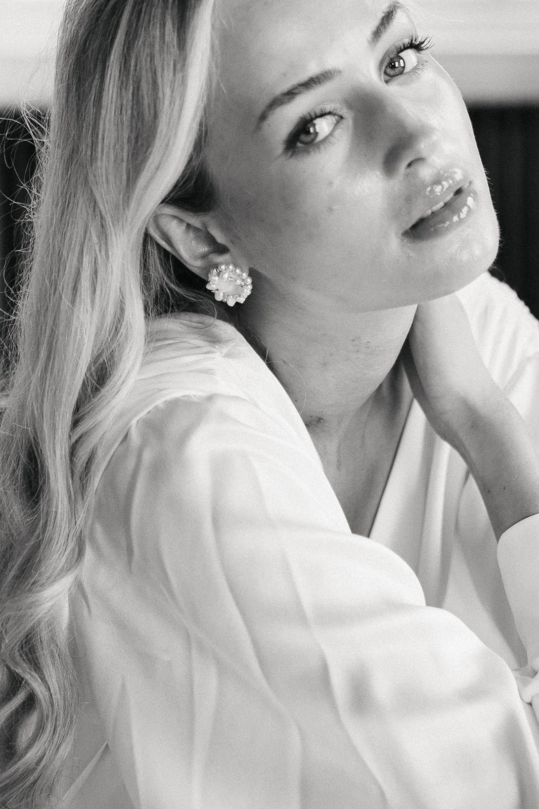 Statement pearl stud earring worn by bride with long hair. 
