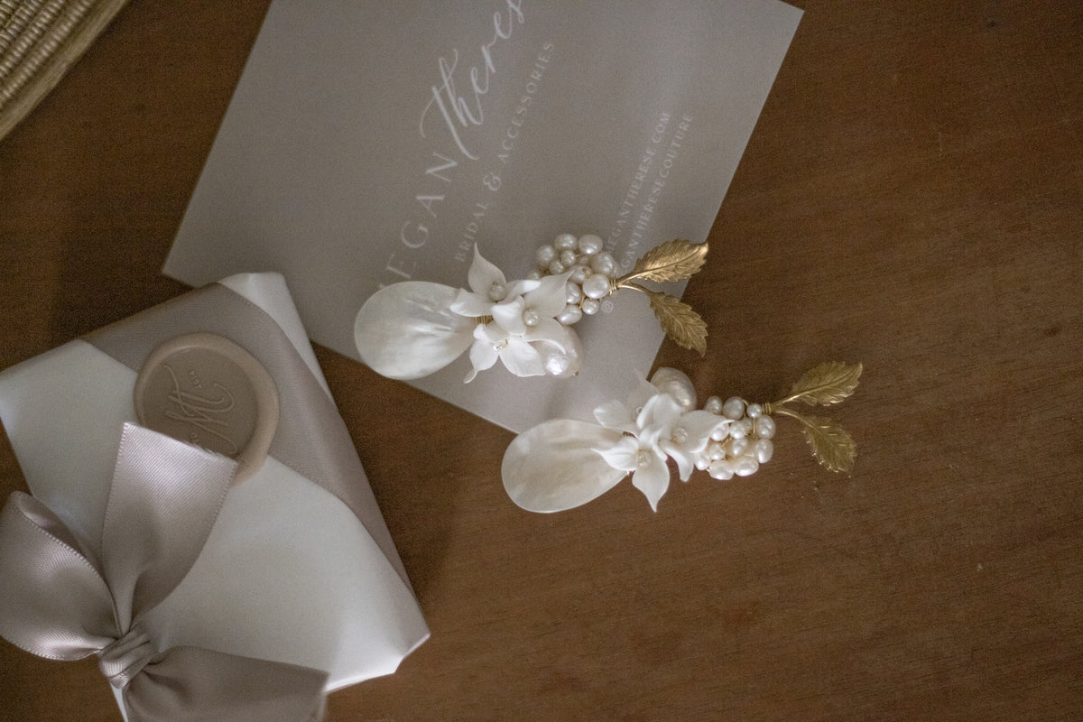 A photograph can capture a beautiful pair of earrings. But there's something entirely different about seeing the delicate curve of a handmade petal, the natural character of a freshwater pearl or the proportions of a design in real life